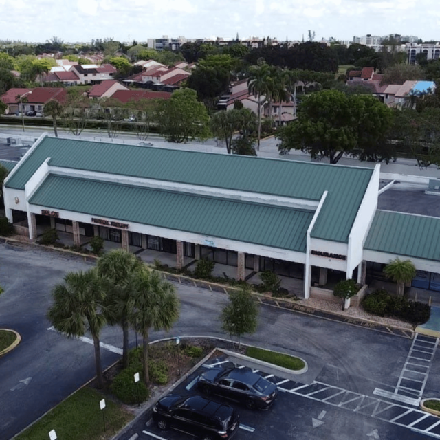 green metal roof plaza oakland park